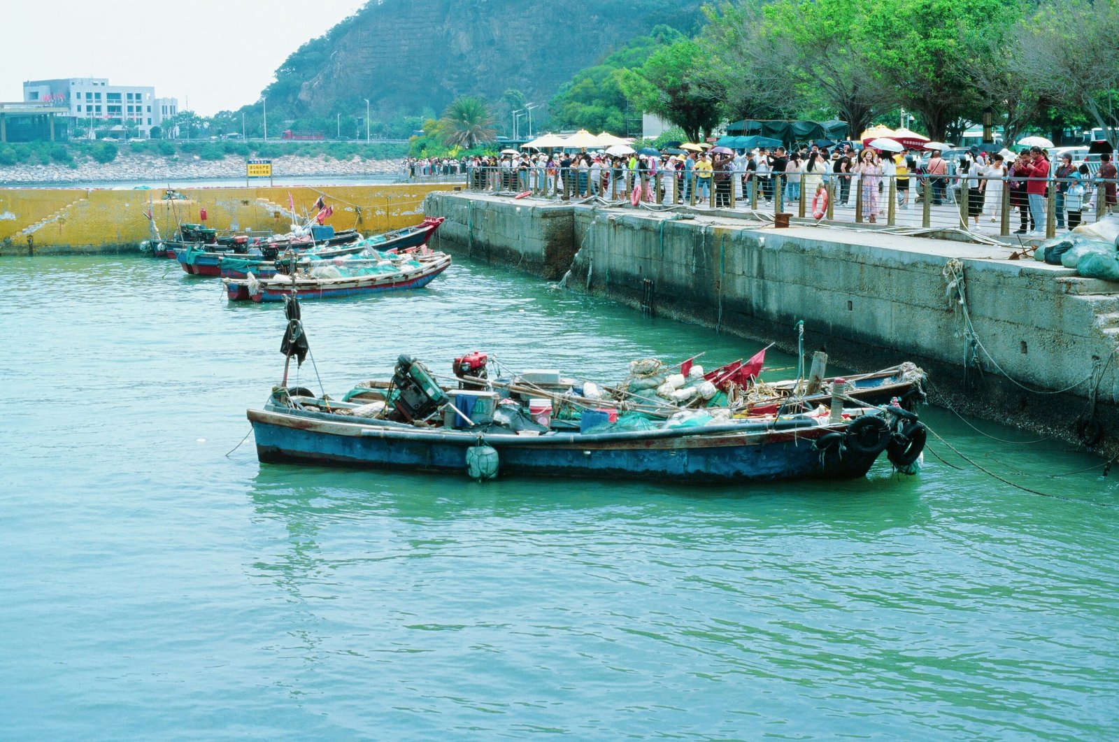 Small fishing boats moored at a concrete pier, representative image for coastal harbours such as Pasni included in Balochistan's fisheries infrastructure push