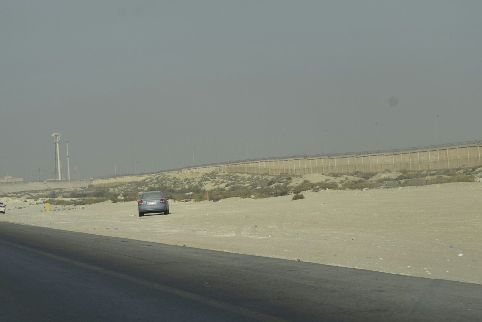 A desert highway with a road barrier, representative image for the delayed M-8 motorway and Eastbay Expressway Phase II road links meant to connect Gwadar