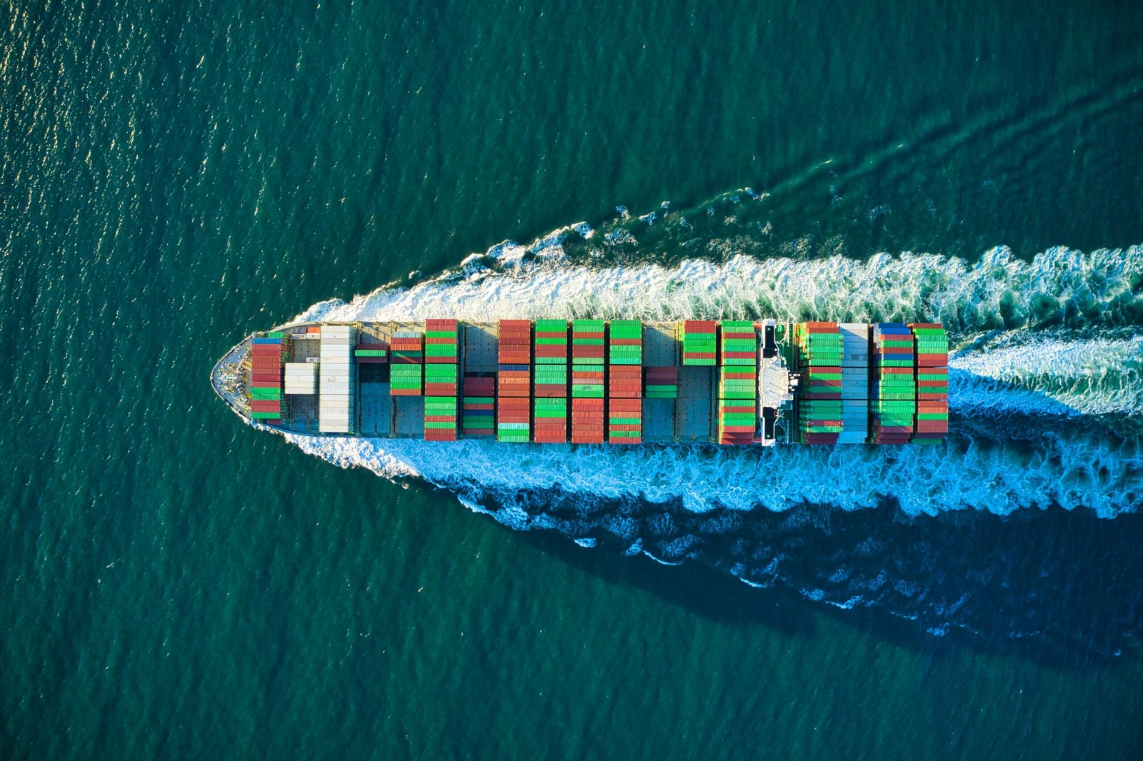 Aerial view of a cargo ship heading out to sea, representing China's continued investment in Gwadar Port