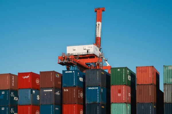 Colorful shipping containers and gantry cranes at a container terminal, illustrating port operations discussed in the Gwadar Port story