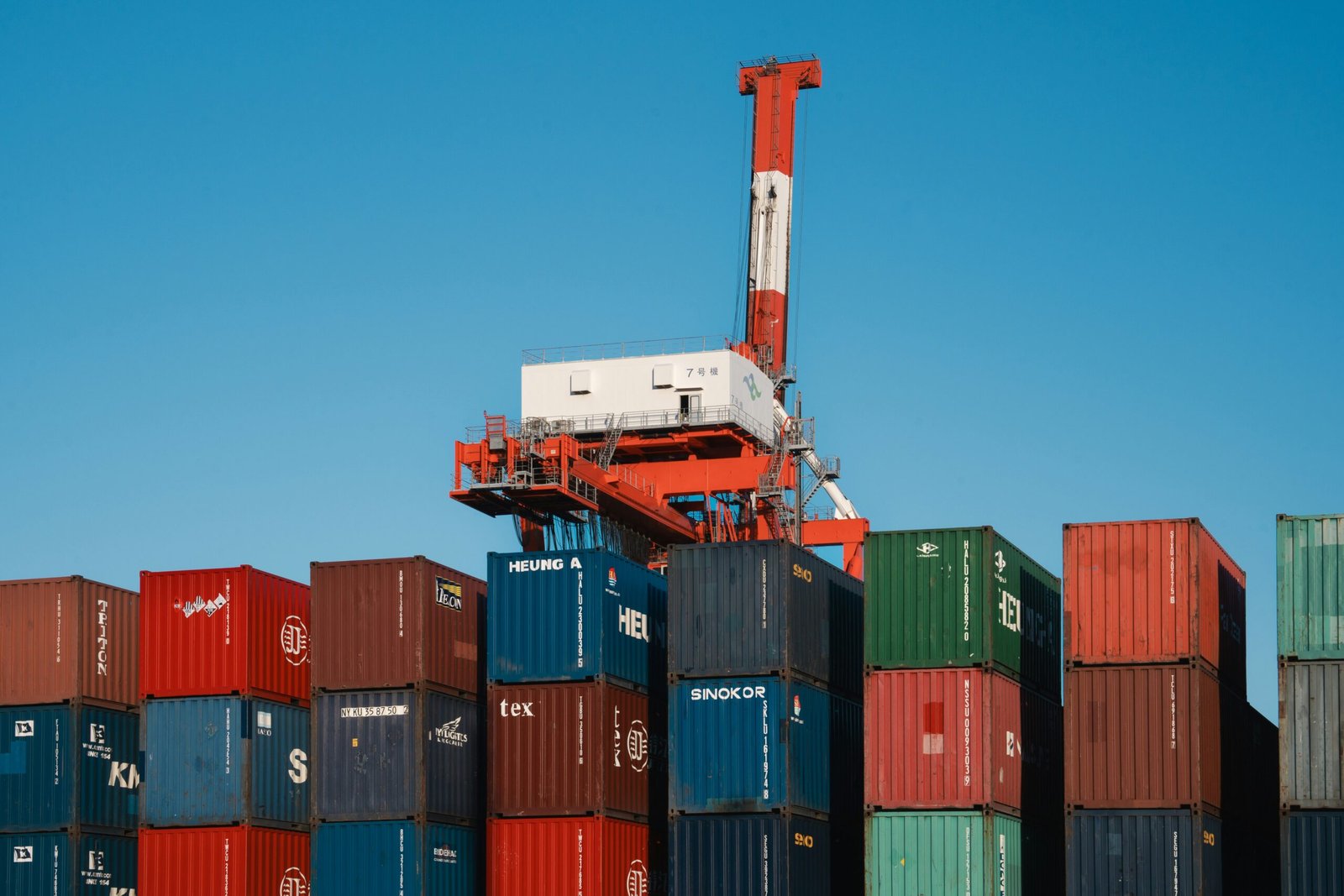 Colorful shipping containers and gantry cranes at a container terminal, illustrating port operations discussed in the Gwadar Port story