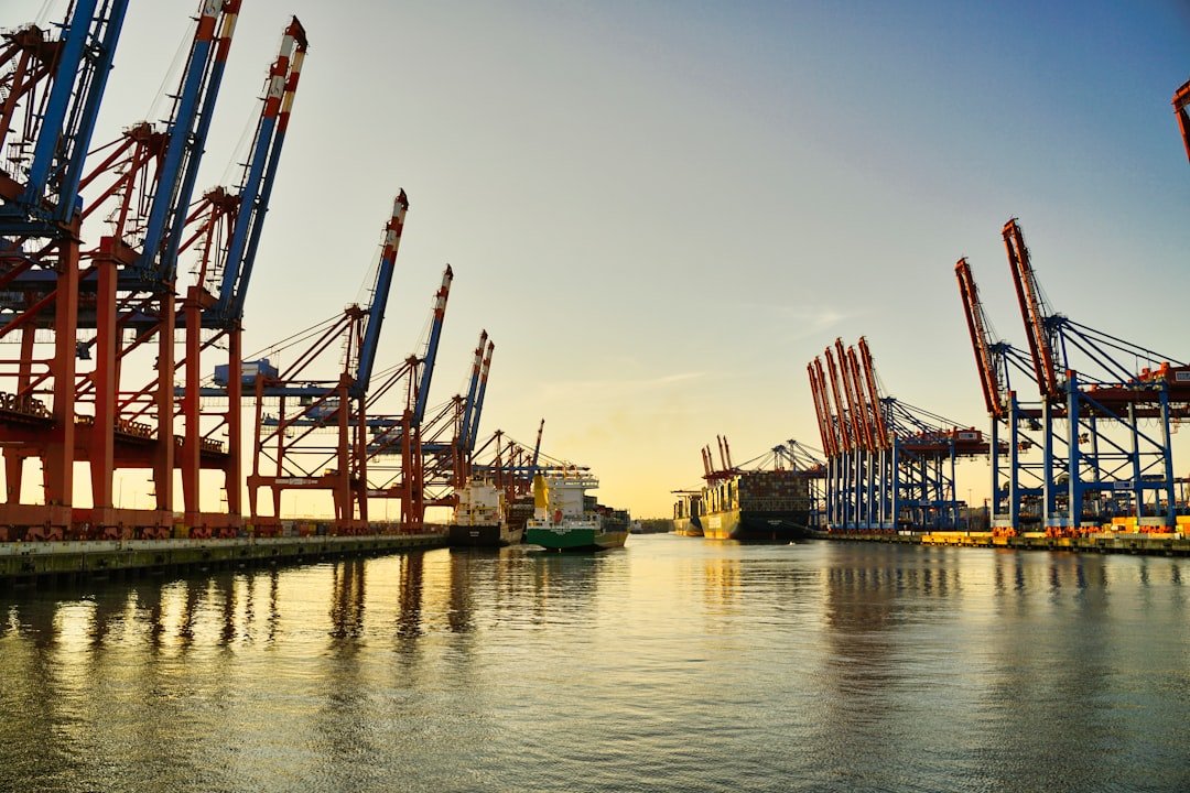 A harbor with large gantry cranes at a container terminal, representing the port operations under China's 40-year Gwadar lease