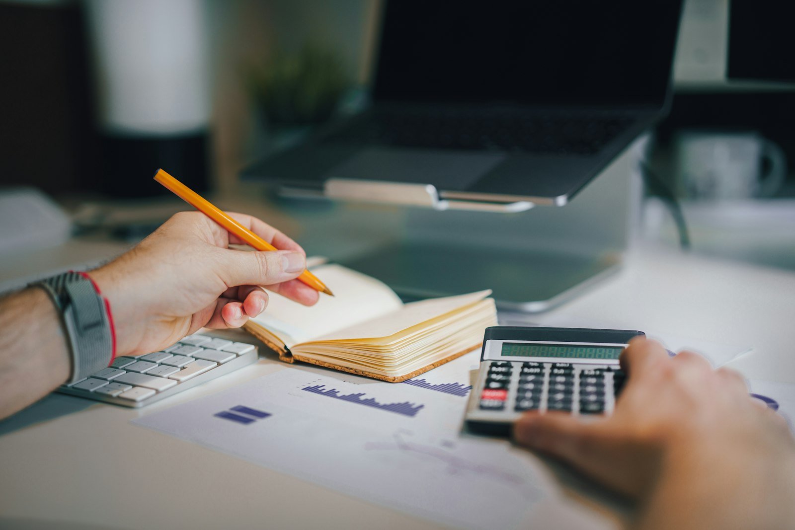 Calculator and financial documents on a desk, representative image for the audit that uncovered financial irregularities in Gwadar's water department