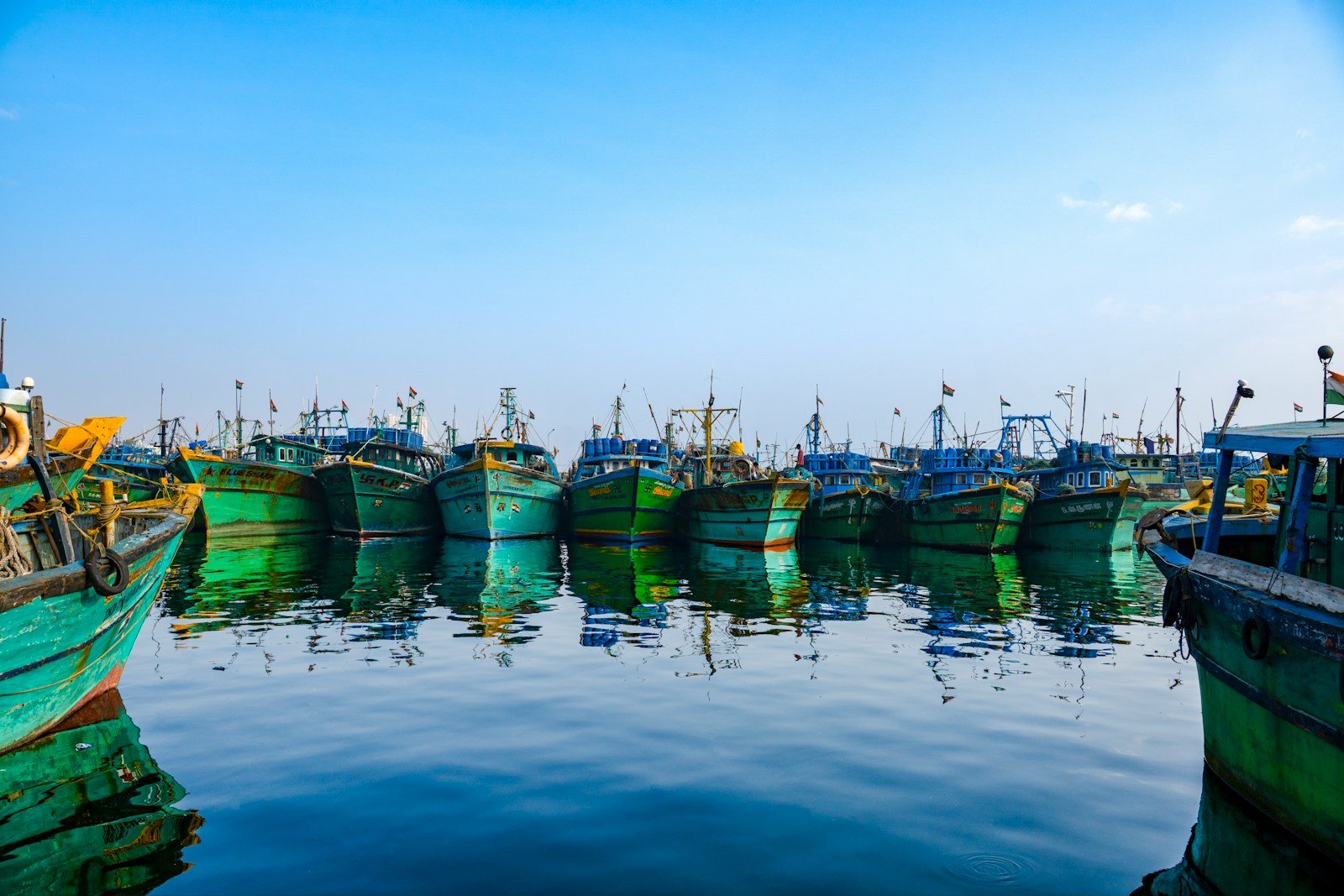 Wooden fishing boats moored together in a coastal harbor, representative image for Gwadar's fishing community