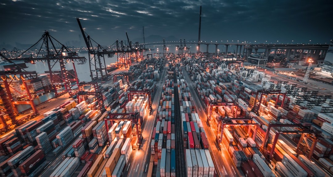 Stacked freight containers at a sea port, representing planned logistics and warehousing investment in the Gwadar Free Zone