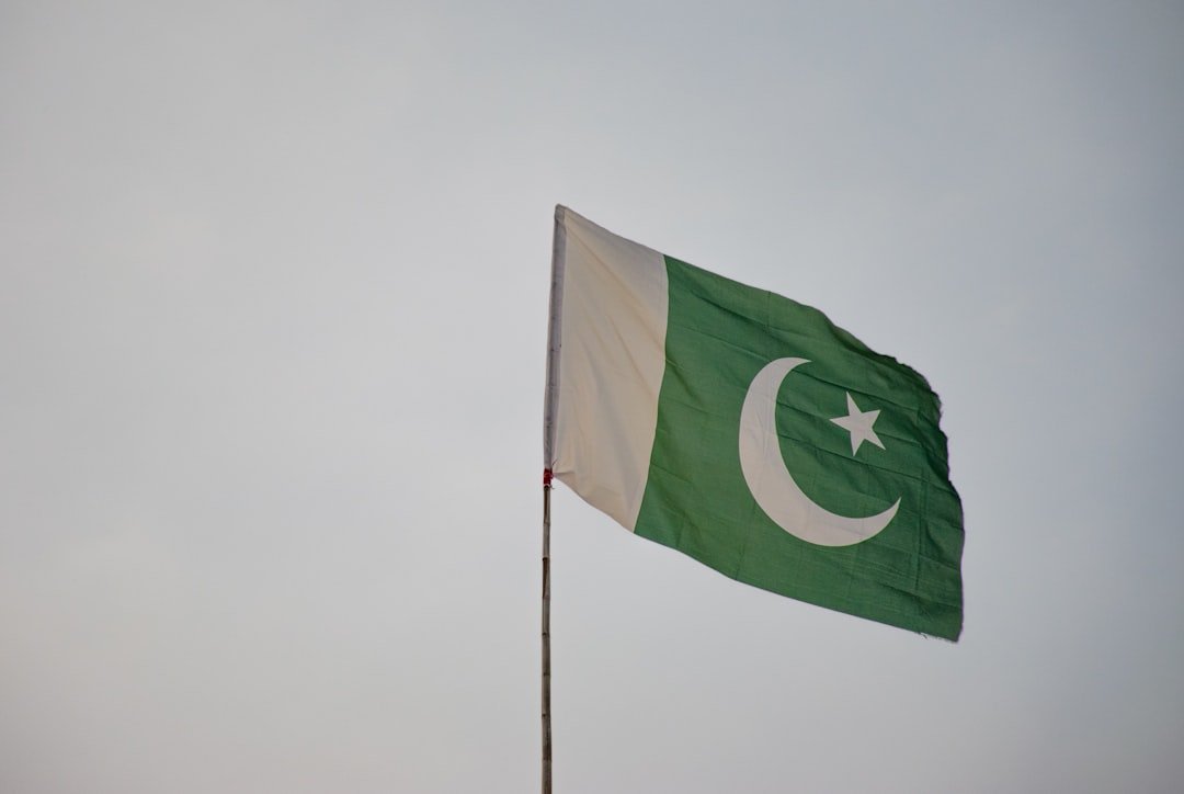 The flag of Pakistan flying against the sky, a representative image for the national debate over redrawing provincial and federal administrative boundaries