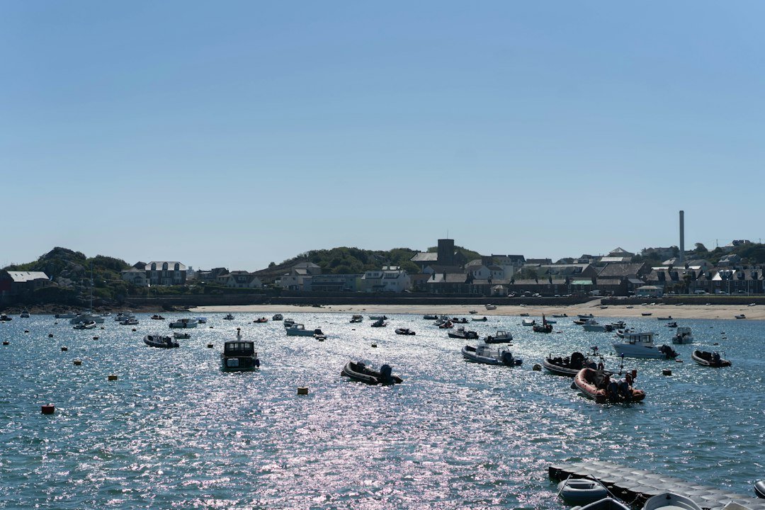 Small boats moored in a sunny harbor near a coastal town, representative image for Pasni, the Makran coast fishing town at the centre of Pakistan's port pitch