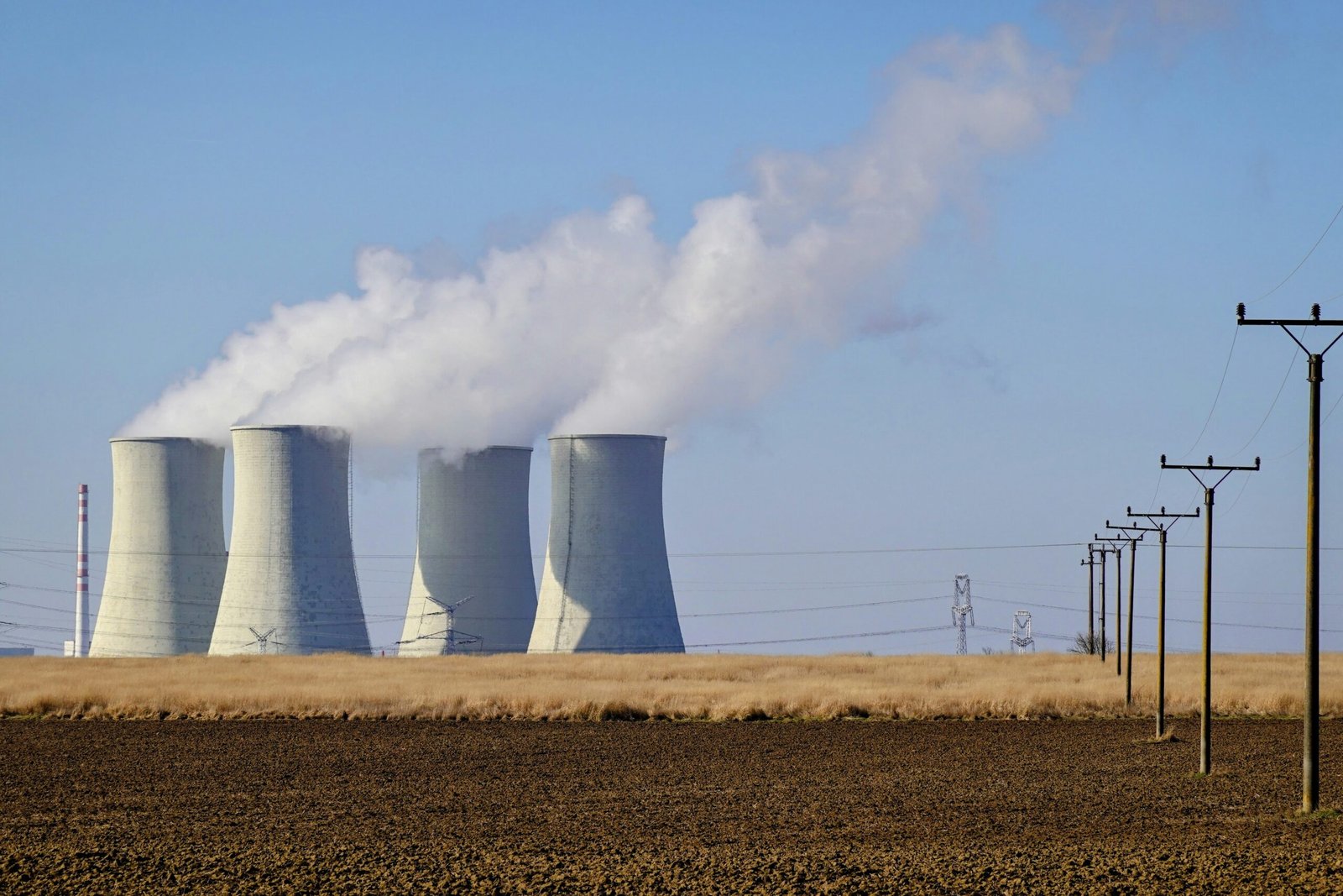 Power plant cooling towers emitting steam, illustrating the energy projects completed under CPEC such as the Sahiwal and Port Qasim coal plants