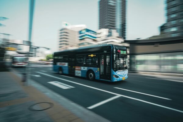 City bus in motion on an urban street, representative image for Quetta's expanding Green Bus electric fleet