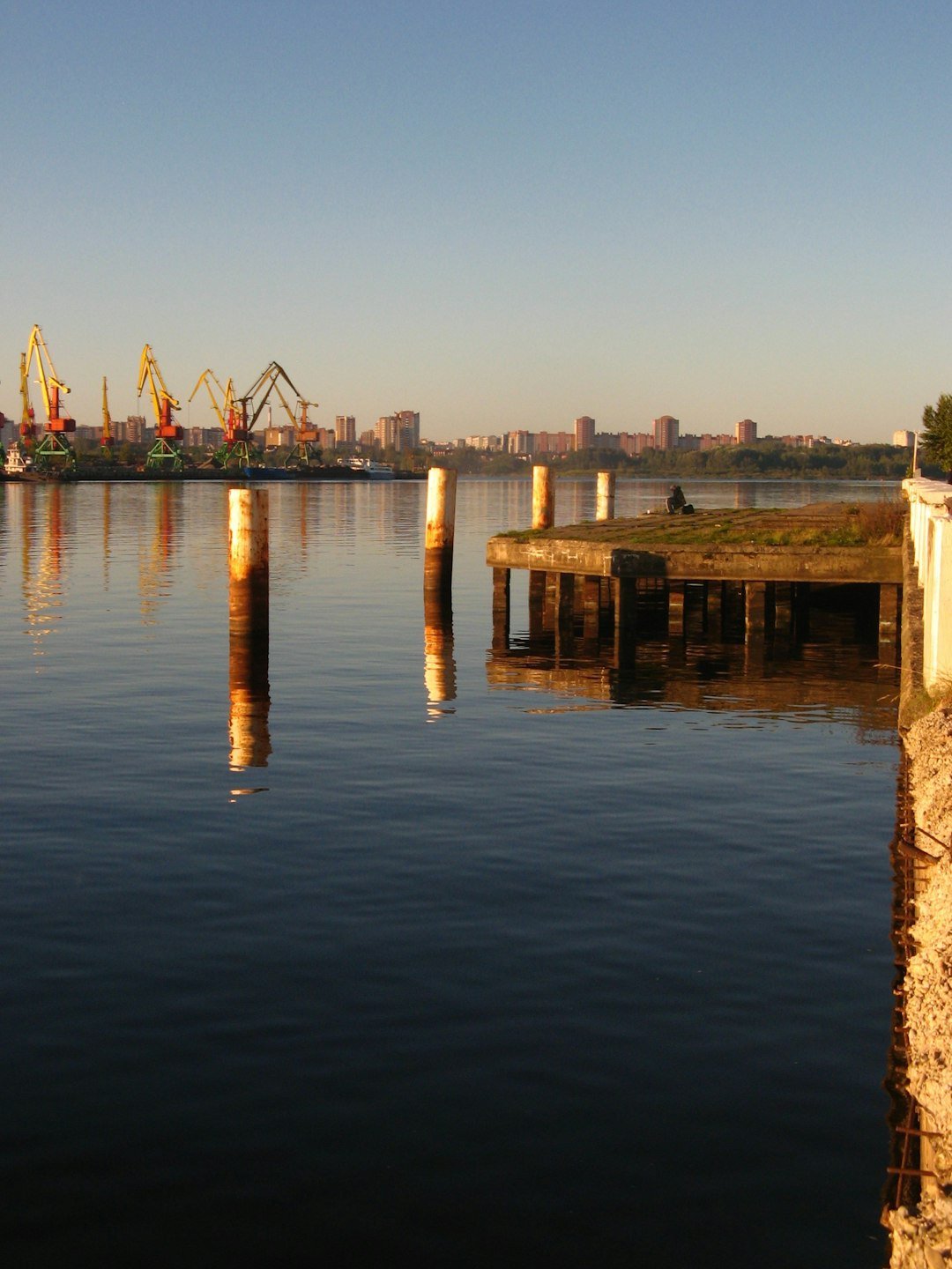 Tranquil harbor at dawn with industrial cranes in the background, representative image illustrating skepticism about Gwadar Port's underused capacity