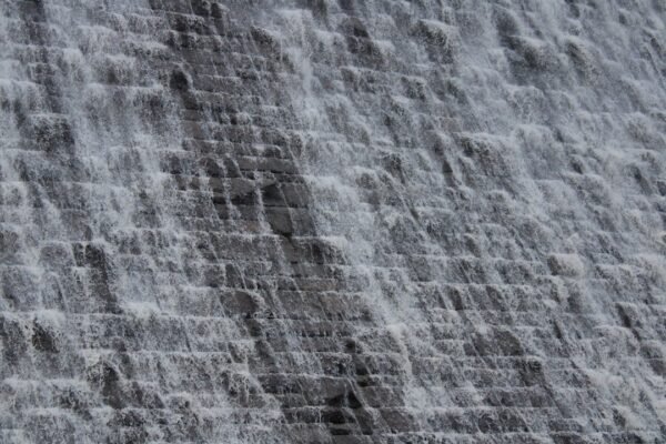 Water cascading down a stone dam face, a representative image of the reservoir infrastructure behind Gwadar's new water supply scheme from Mirani Dam