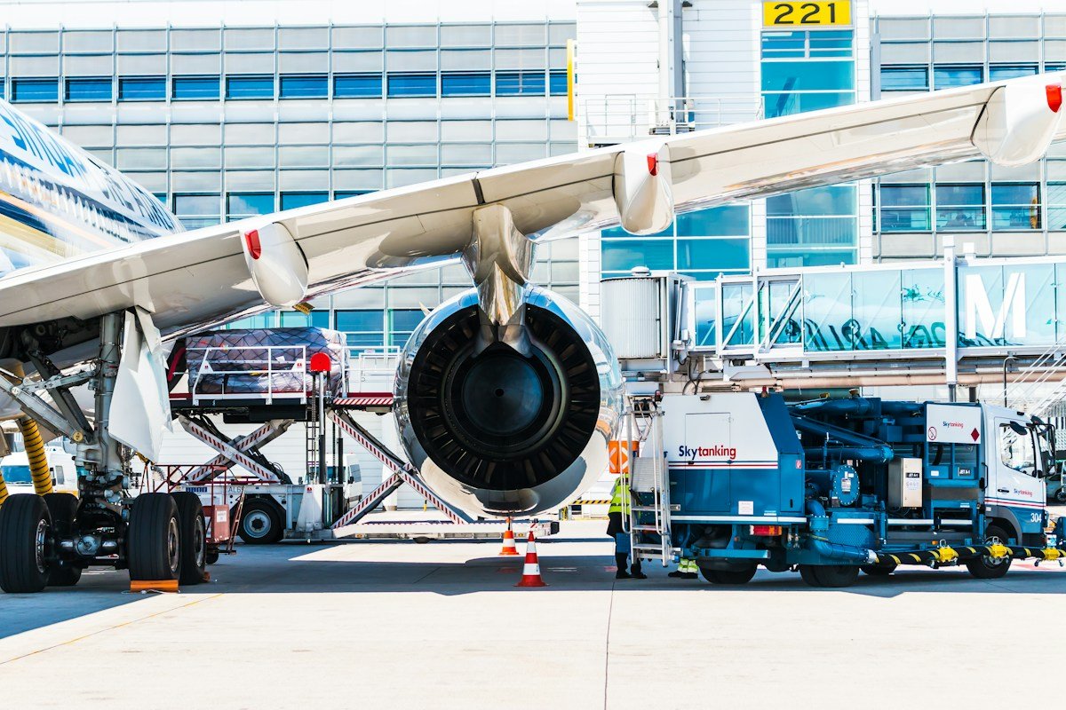 A fuel vehicle parked beside an aircraft on the tarmac, representative of the temporary refueling station set up at Gwadar's airport in partnership with Pakistan State Oil