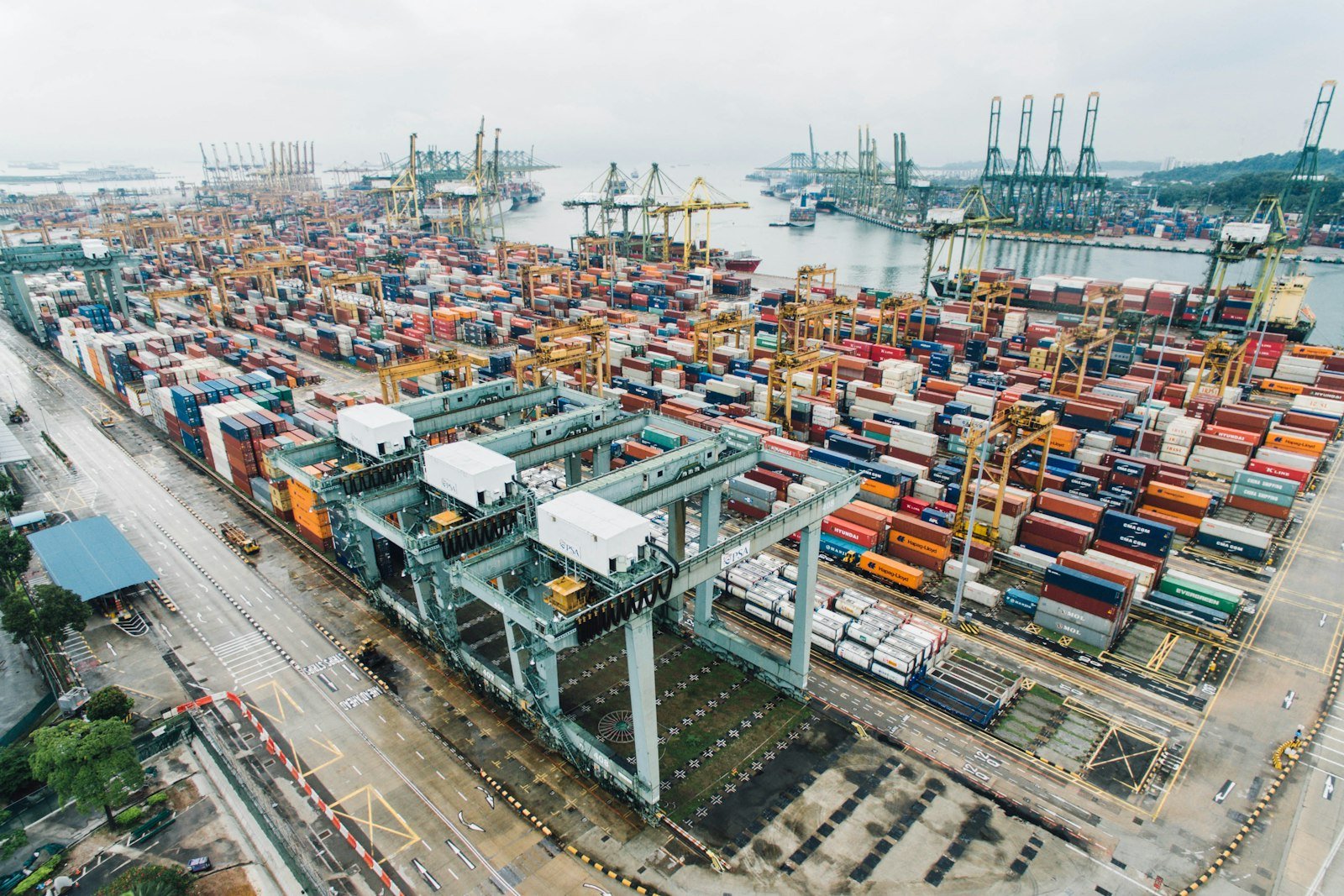 A busy cargo port with stacked containers and loading cranes, representative image for the trade volumes Gwadar Port is trying to capture