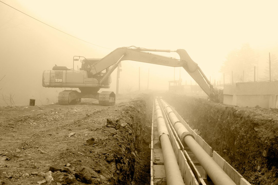 Large drainage pipes beside an excavator at a construction site, representative image for sewage and rainwater drainage works under Gwadar's infrastructure review