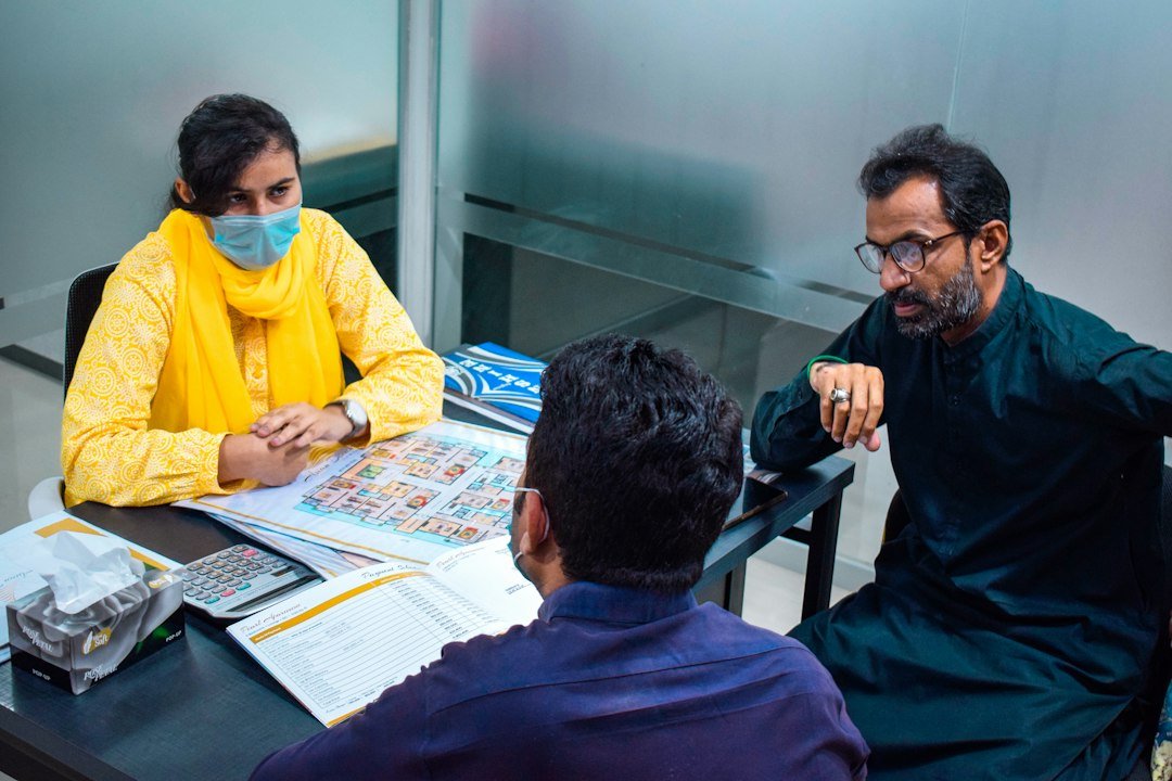 Officials seated around a table in discussion, representative image for the district administration's hearing on Gwadar New Town land disputes