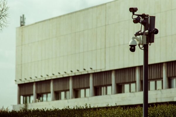 A multi-camera surveillance pole stands in front of a building, representative image for Gwadar's Safe City camera network