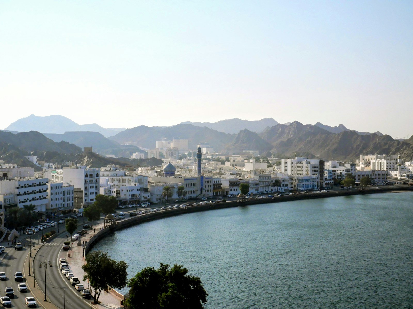 Wide view of the Muttrah Corniche and harbor in Muscat, Oman, representative image for Oman's maritime sector and its proposed sister-port link with Gwadar