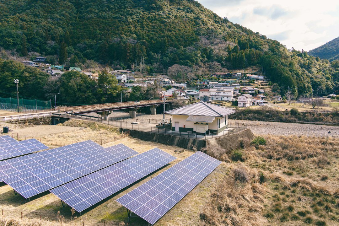 Solar panels installed in a rural village with mountains in the background, representative image for solar home systems being distributed to households in Balochistan under CPEC-linked social projects