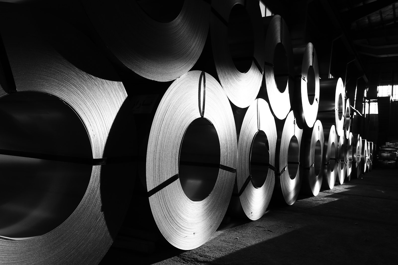 Rolls of steel stacked in an industrial warehouse, representative image for the steel billet cargo that was diverted to Gwadar Port for transshipment in May 2026